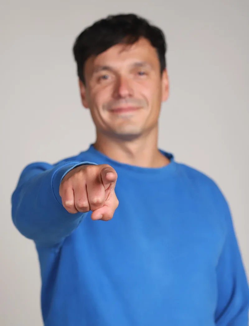 Predrag Tasevski, founder of Unicis, pointing towards the viewer